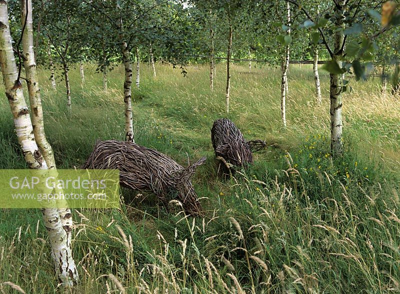 Willow pigs in meadow - Merriments garden, Sussex