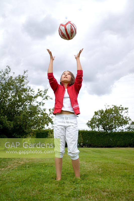 Young girl catching ball