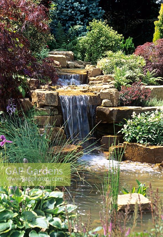 Water garden with sandstone rock waterfall