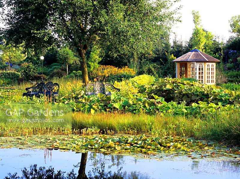 Country garden with pond and pavillon in background