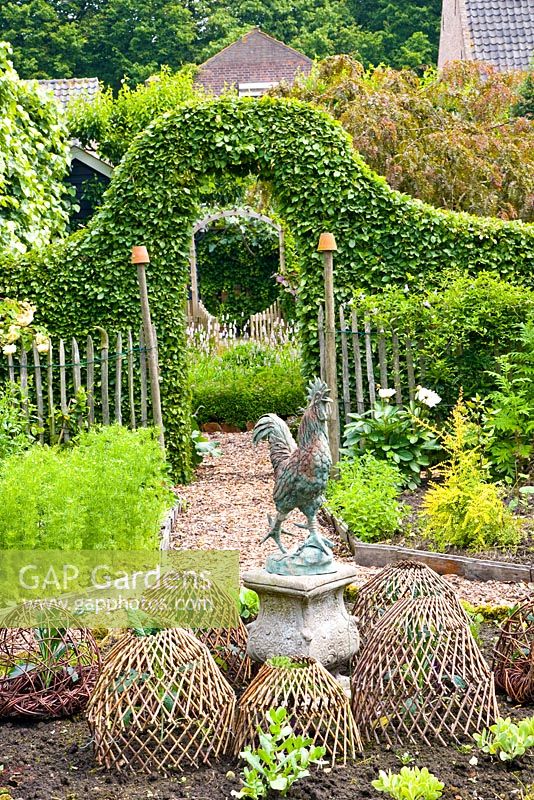 Ornamnetal kitchen garden with cockerel statue