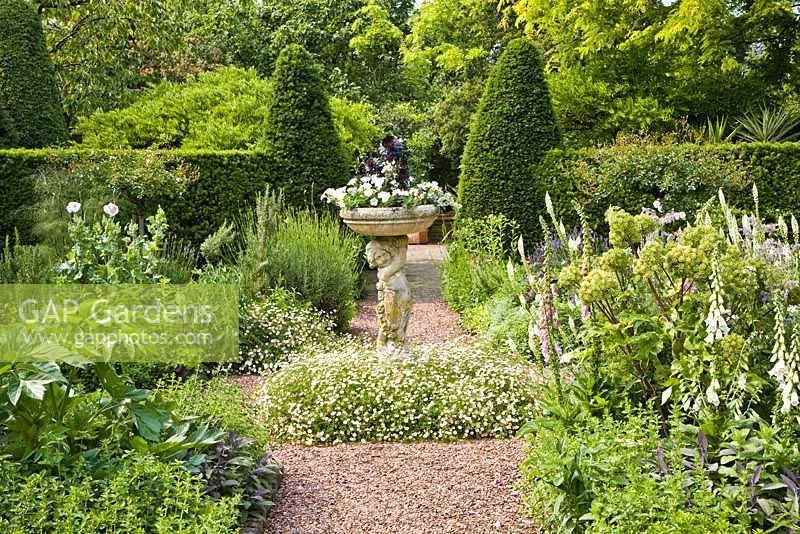 Formal garden with central stone ornament