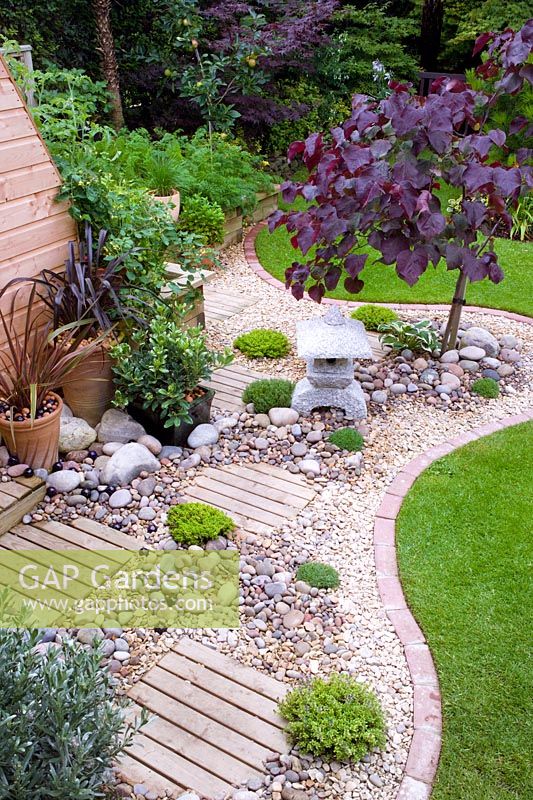 Dry gravel area with oriental feel, mixed materials in small town garden with good structure, interesting trees and shrubs - Nailsea, Somerset, UK 