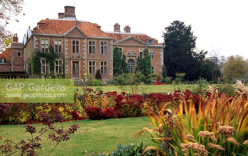 View of South facade of Heale House with Croquet Lawn, Musk Rosa border underplanted with Sedum 'Autumn Joy'