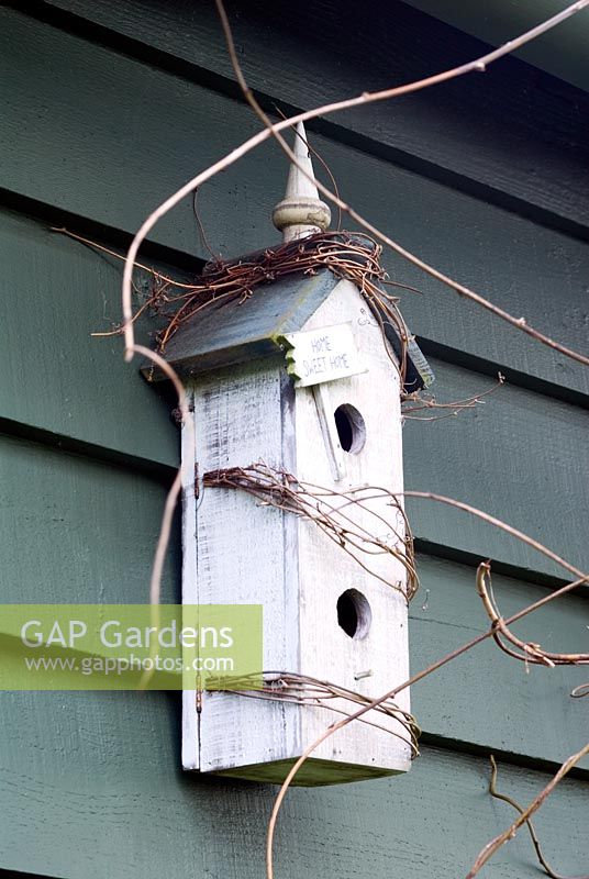 Painted Shaker-style bird box on painted timber weatherboard
