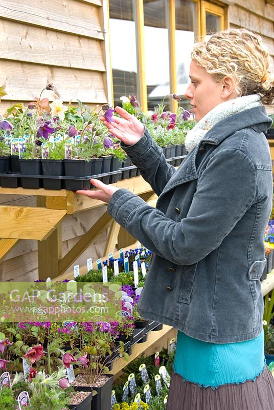 Lady buying plants in garden centre