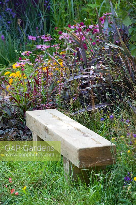 Wooden Bench made from oak beams in a wild flower area of a garden - Hope, The Way Forward - Hampton Court 2008