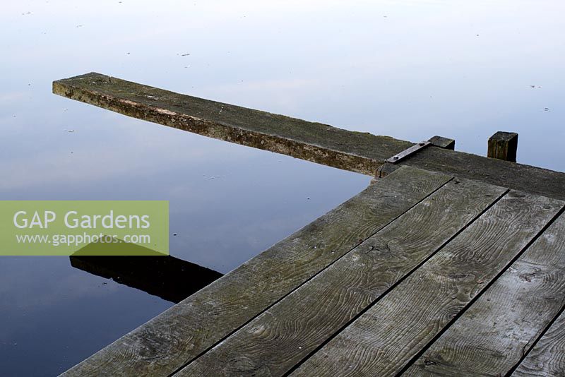 Wooden jetty and diving board on lake