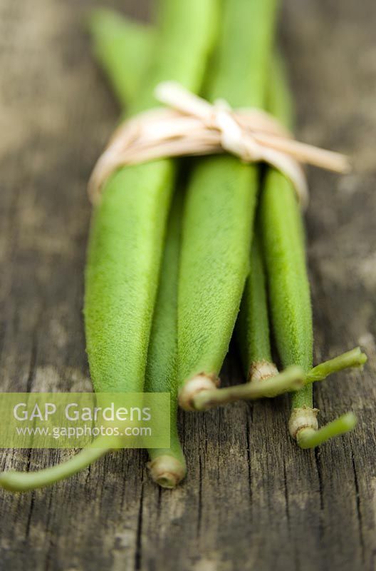 Runner beans on wooden surface