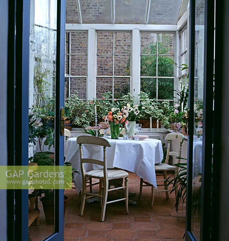 Conservatory with table, chairs and houseplants