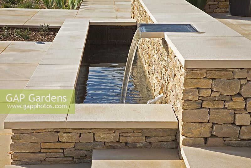 Raised limestone contemporary water feature on a large terrace