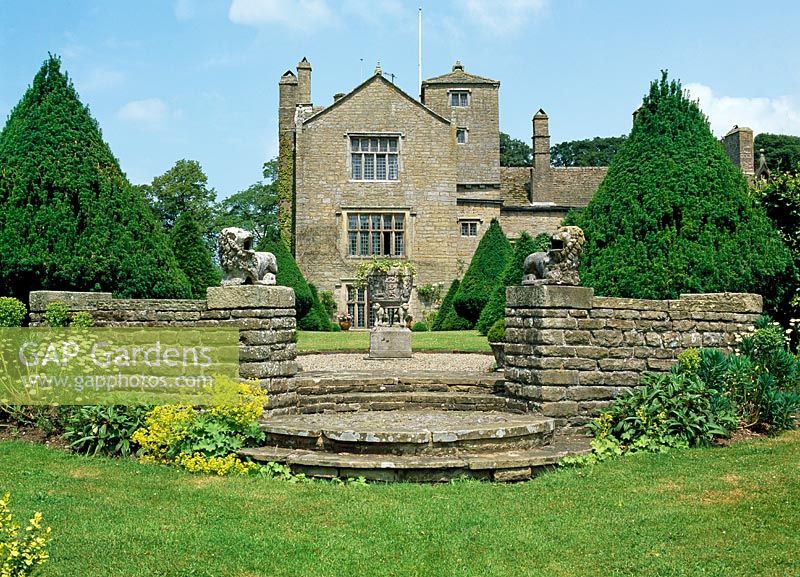View of the hall from stone terrace with Yew avenue - Lawkland Hall, Yorkshire