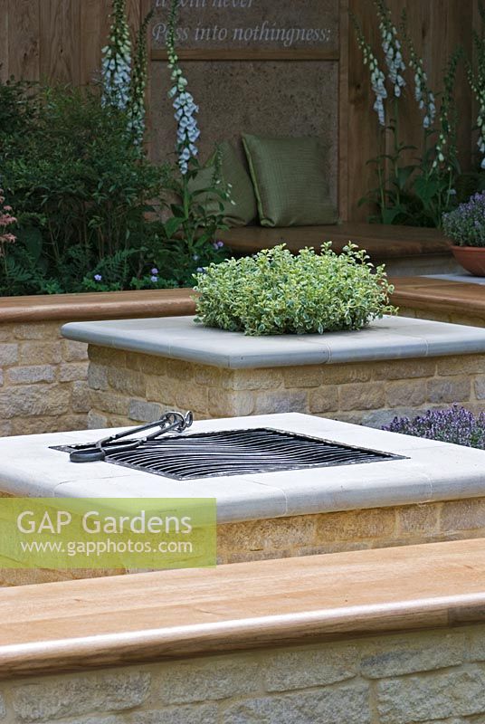 Thymus vulgaris in a raised brick planter with seating and a Barbeque - The QVC Garden, sponsored by QVC - Silver Flora medal winner at RHS Chelsea Flower Show 2009