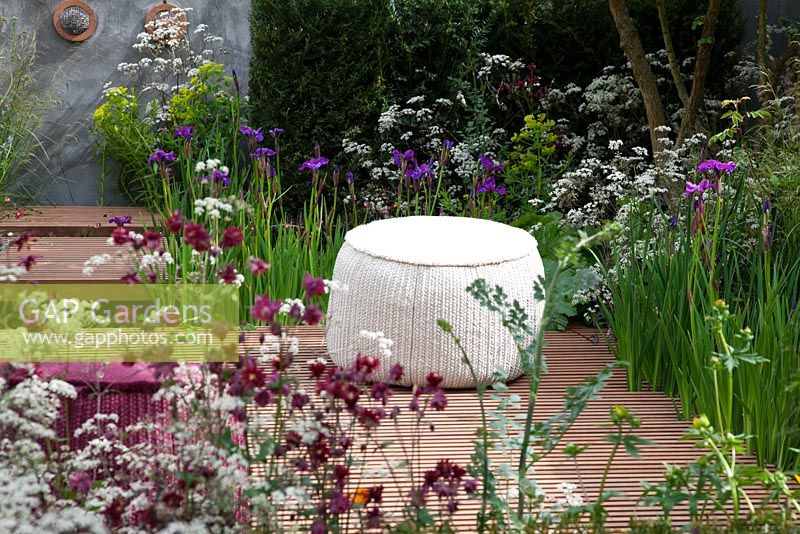 Naturalistic planting to attract a diverse range of insects surround a timber seating area, planting includes Acer campestre, Taxus baccata, Cirsium rivulare, Anthriscus sylvestris 'Ravenswing', Iris germanica, Euphorbia palustris, Digitalis, Deschampsia caespitosa and Aquilegia 'Ruby Port' - Nature Ascending Garden - Gold medal winner for Urban Garden at RHS Chelsea Flower Show 2009  