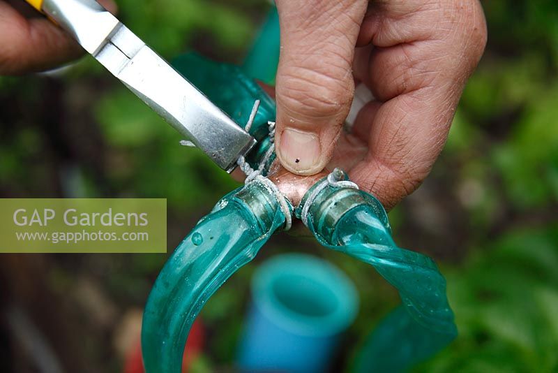 Garden watering system - Step 6 - Use soft wire to secure the seep hose to the copper fitting