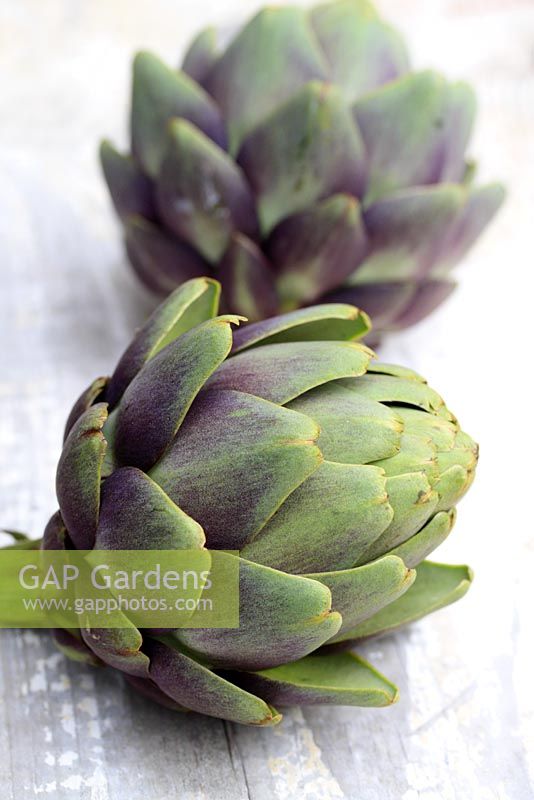 Artichokes on wooden surface