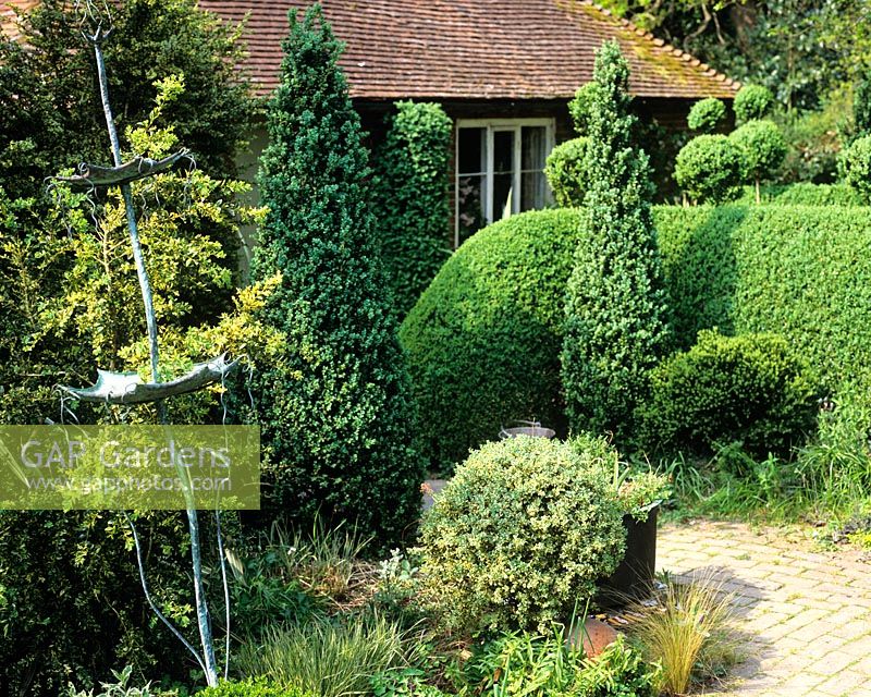 Metal sculpture in topiary garden - Charlotte Molesworth's garden, Kent