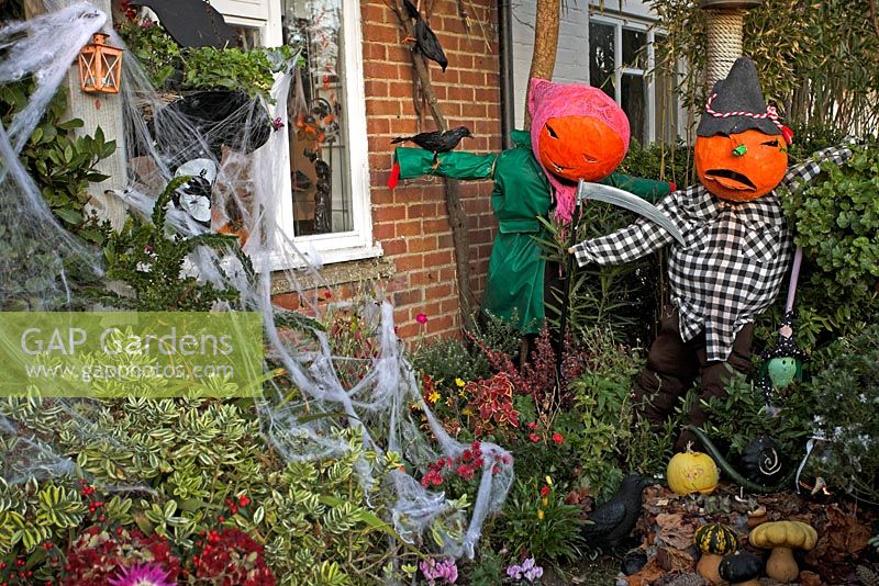 Halloween decorations of scary Pumpkin headed scarecrows 