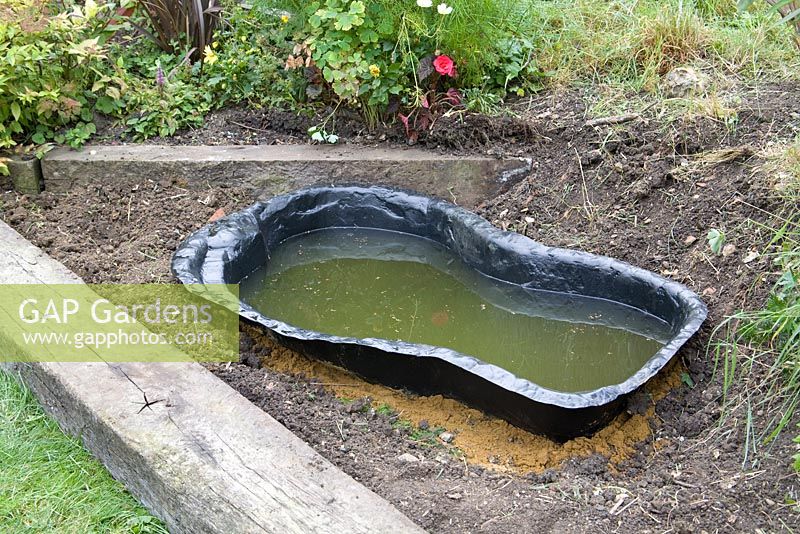 Garden pond project - step by step - moulded lining filled with water