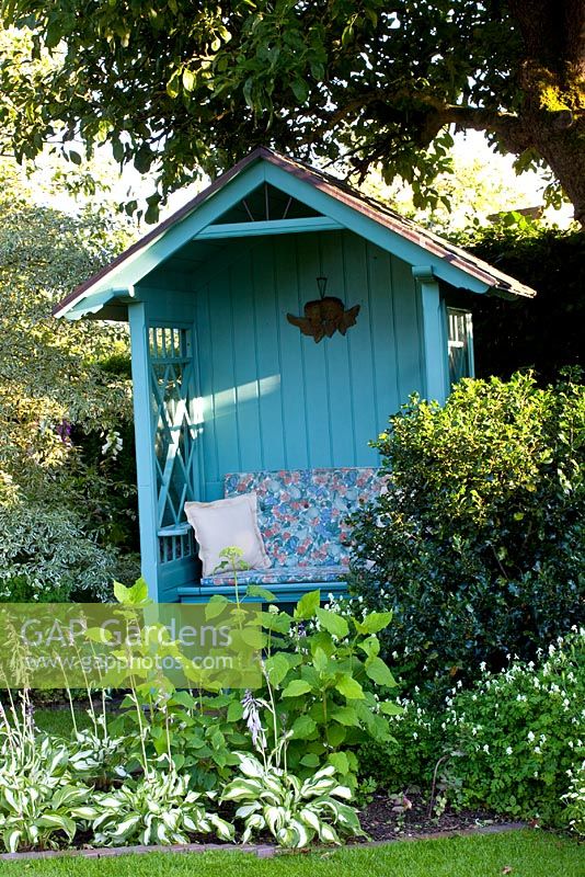 Painted gazebo in country garden