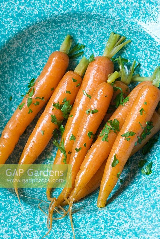 Cooked carrots in a blue bowl