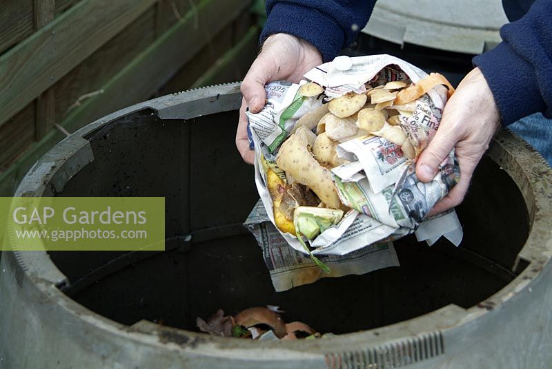 Adding food waste to compost bin
