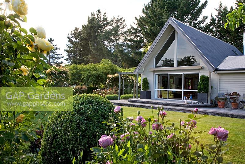 Herbaceous flowerbeds and view of house - Breedenbroek, New Zealand