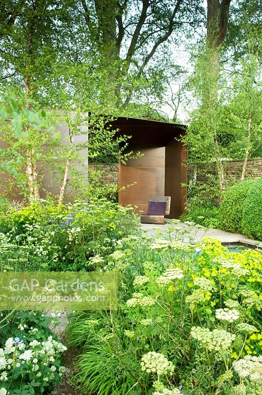 Pavilion designed by Jamie Fobert, seat, rectangular pool and borders of Euphorbia wallichii, Astrantia major 'White Giant', Iris, Cenolophium denudatum, Betula and clipped Buxus sempervirens - The Laurent-Perrier Garden, Gold medal winner, RHS Chelsea Flower Show 2010 