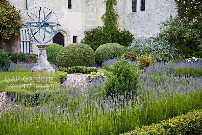 Formal parterre with clipped Box, Lavandula and orb statue - Rymans, Sussex