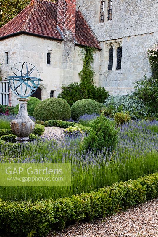 Formal parterre with clipped Box, Lavandula and orb statue - Rymans, Sussex