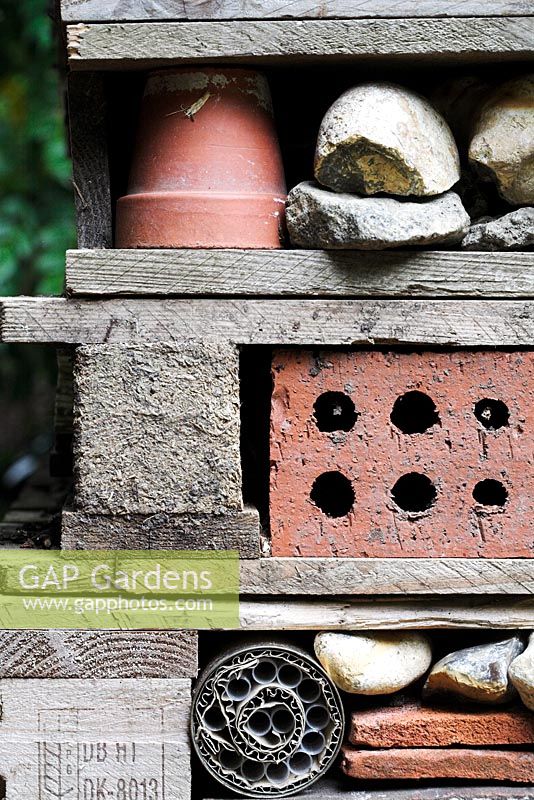 Insect habitat created with pallets, bricks, pots, stones, bark and piping for insects such as ladybirds, bees and lacewings to hibernate over winter