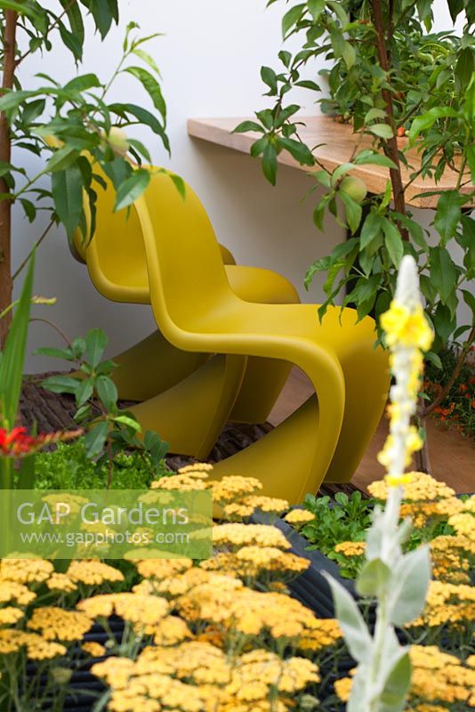 Seating area planted with Achillea - Yarrow. 'Food 4 Thought' - Gold Medal Winner - RHS Hampton Court Flower Show 2010 