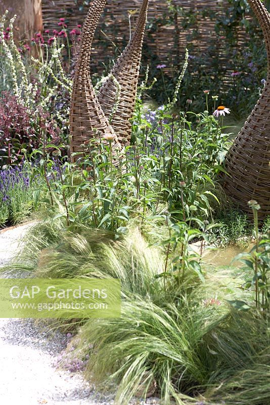 Willow structures in borders in wildlife garden. 'It's Only Natural' - Silver Gilt Medal Winner - RHS Hampton Court Flower Show 2010 