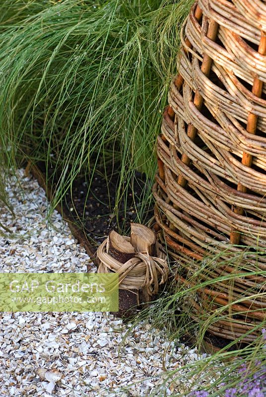 Cockleshell path with edging post hand tied in willow and Stipa tenuissima. 'It's Only Natural' - Silver Gilt Medal Winner - RHS Hampton Court Flower Show 2010 
 