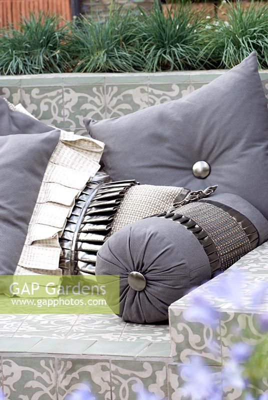 Outdoor, waterproof cushions on a tiled sofa. 'The Garden Lounge' - Silver Gilt Medal Winner - RHS Hampton Court Flower Show 2010 
 