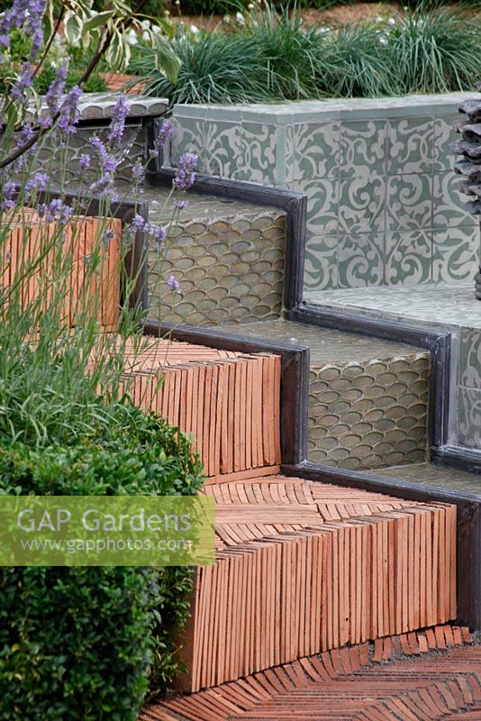 Herringbone terracotta tiled steps and water feature. 'The Garden Lounge' - Silver Gilt Medal Winner - RHS Hampton Court Flower Show 2010 
 
