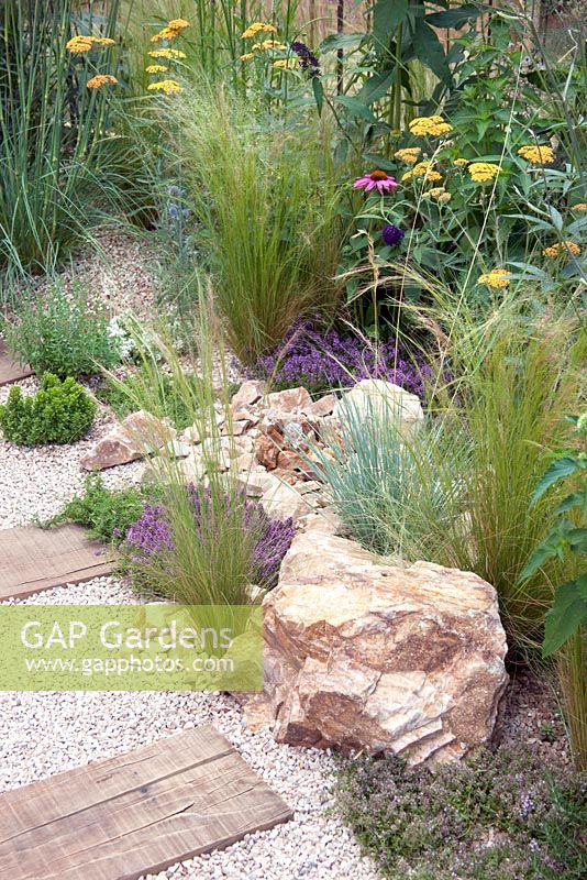 Crushed recycled ceramic gravel path, plantings of Achillea 'Terracotta', Stipa arundinacea, Echinacea purpurea, Rosmarinus officinalis and Thyme - 'The Firepit Garden', Silver Medal Winner at the RHS Hampton Court Flower Show 2010 
