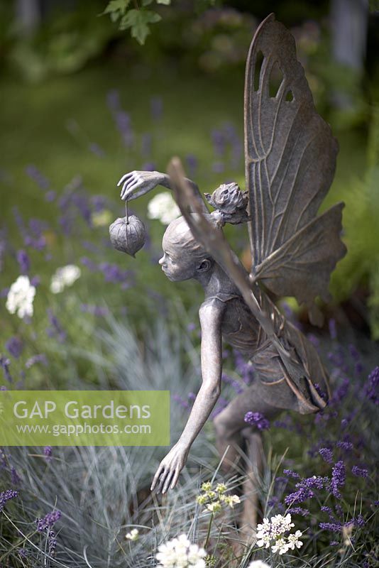 Fairy sculpture holding cape gooseberry in Lavender. 'A Midsummer Night's Dream' - Silver Medal winner - RHS Hampton Court Flower Show 2010 