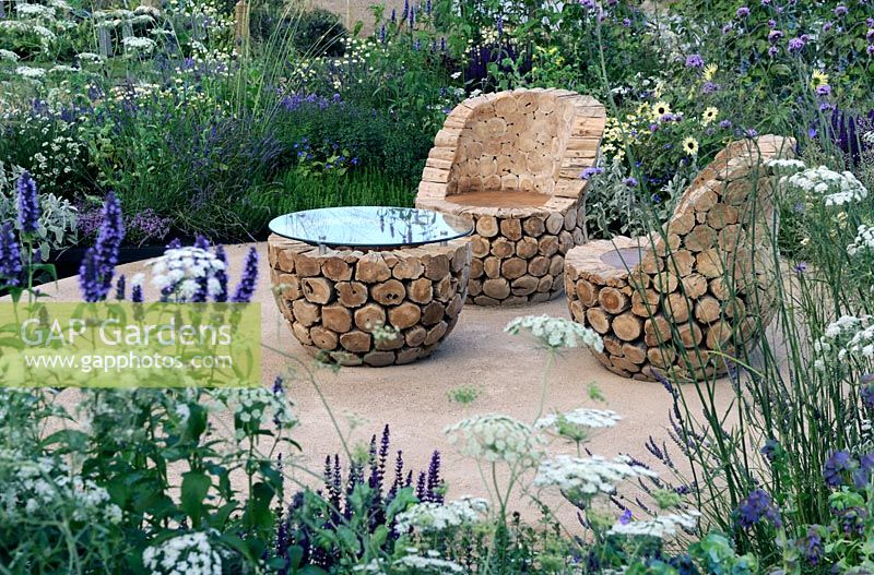 Teak log chairs and table - 'The Copella Bee Garden', Silver Gilt medal winner at RHS Hampton Court Flower Show 2010
 
