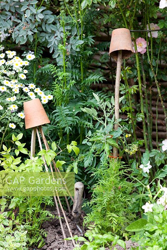 Old clay pots used as cane toppers and wigwam toppers.