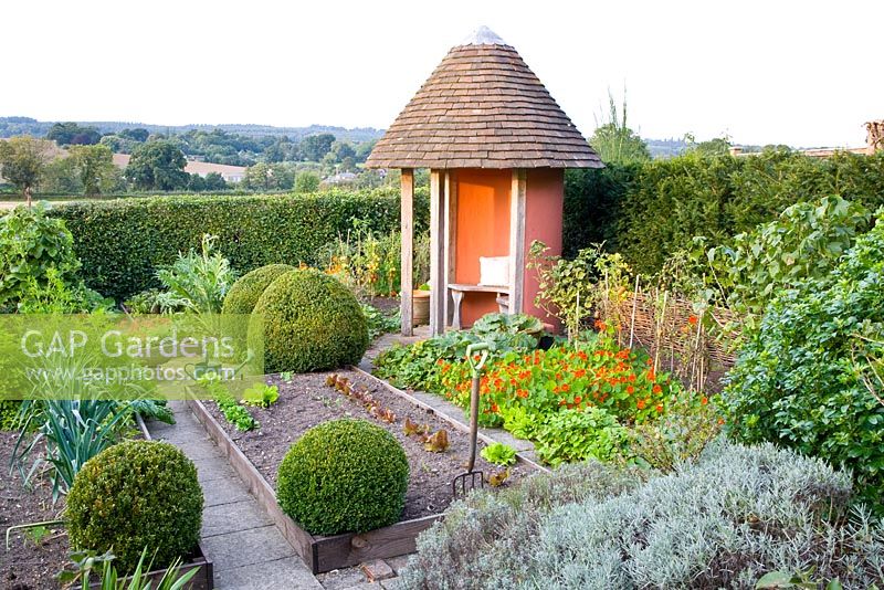 Potager with gazebo and view to countryside in late summer 