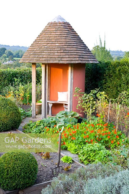 Potager with gazebo and view to countryside in late summer 
