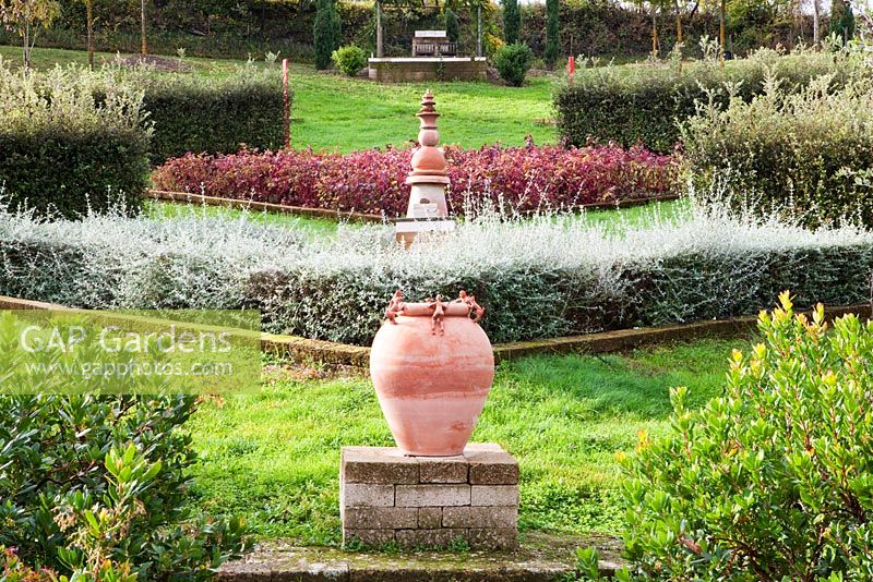 Lines of terracotta urns on plinths.The Field. Il Bosco Della Ragnaia, San Giovanni D'Asso, Tuscany, Italy, October. 
 