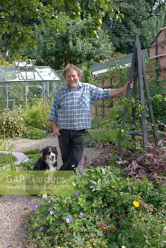 Ian Huckson who designed, constructed and maintains the garden with his dog, Daisy at Church View, Appleby-in-Westmorland, Cumbria NGS