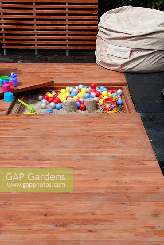 Contemporary play garden for children with sandbox design in the wooden decking. BLOOM flowershow 2010, Dublin, Ireland.