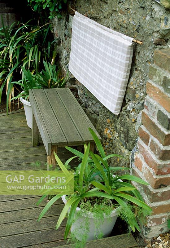 Wooden bench made from wooden decking. Late Spring,  Fovant Hut Garden, Wilts.