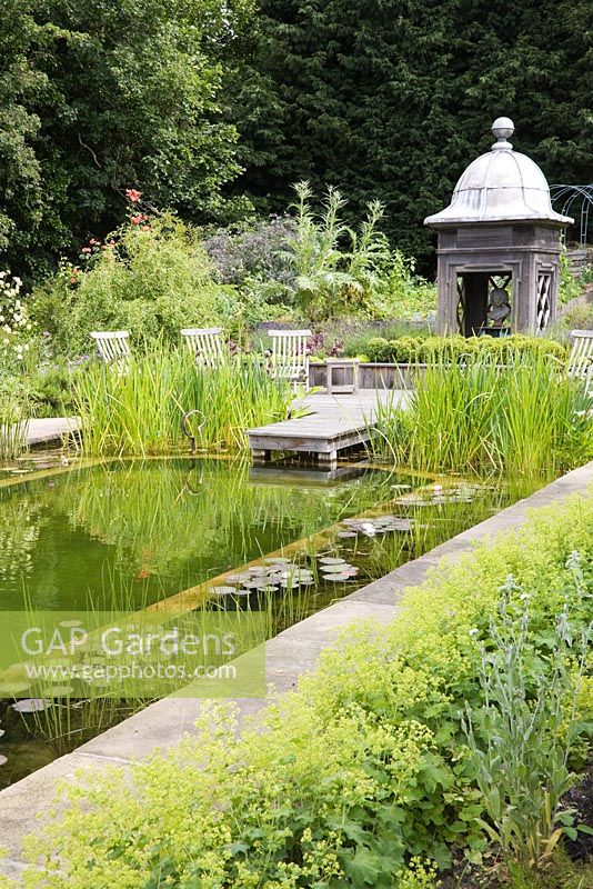 Natural swimming pool with marginal planting and and decorative cupola