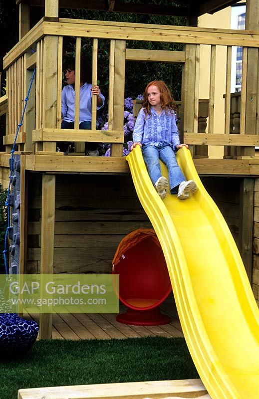 Children on slide in the Two point four children garden - RHS Hampton Court Flower show 2004