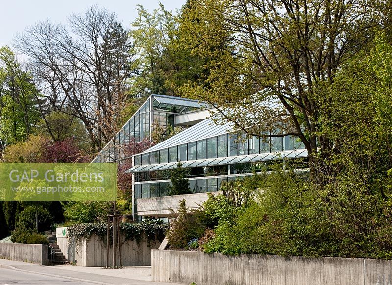 View from the road to the glasshouse with one tropical and one with subtropical climate - Wintergarten, Germany