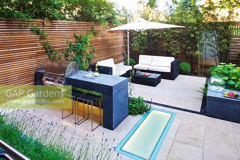 Modern garden with barbecue and dining area
